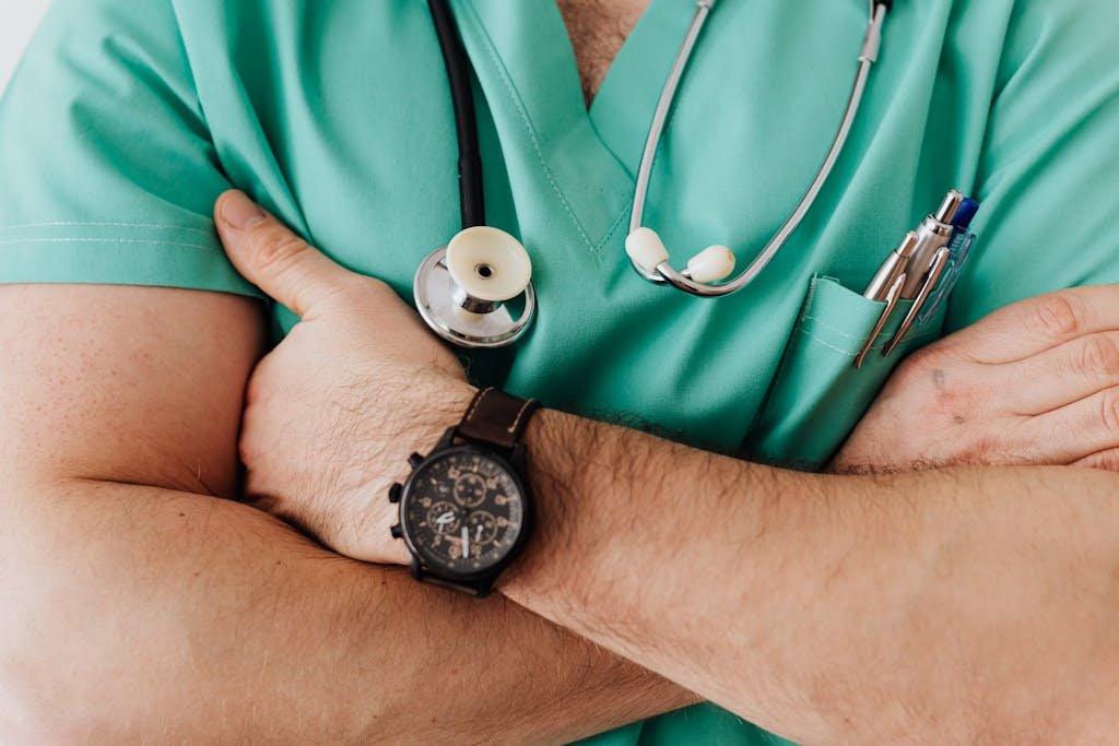 Electroconvulsive Therapy (ECT) Close-up of a healthcare professional with arms crossed wearing medical scrubs and stethoscope. ECT